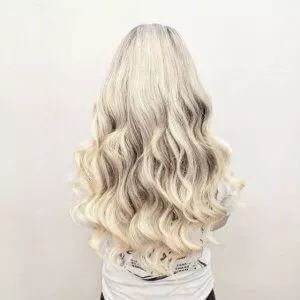 long blond wave hair extensions on client